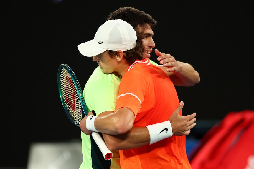 Alex de Minaur hugs Carlos Alcaraz