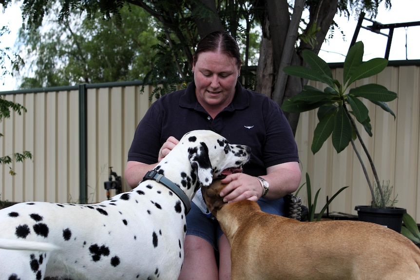 Mai Cameron patting her dogs