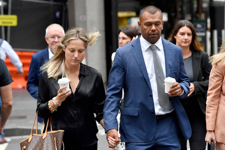 Kurtley Beale walks hand in hand with his partner