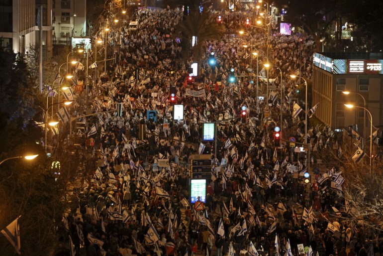 Protesters gather for an 11th straight week of protests against the government's controversial judicial overhaul bill in Tel Aviv on March 18, 2023.