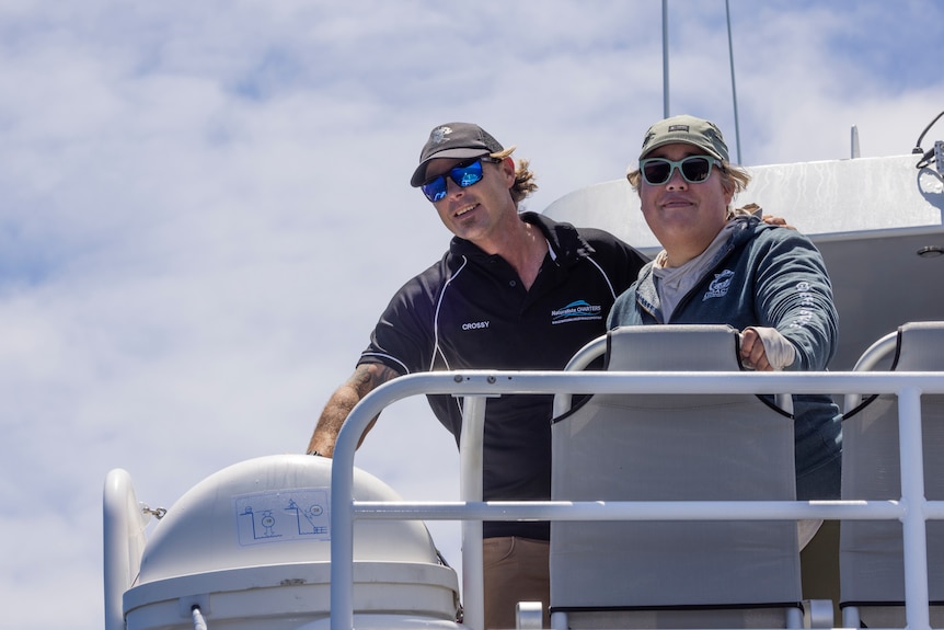 two people in sunglasses on a boat