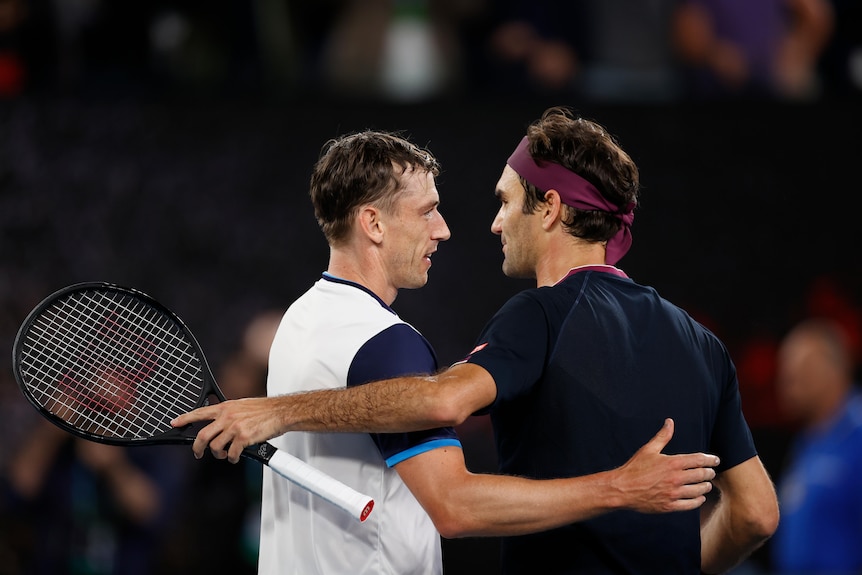 Roger Federer hugs John Millman