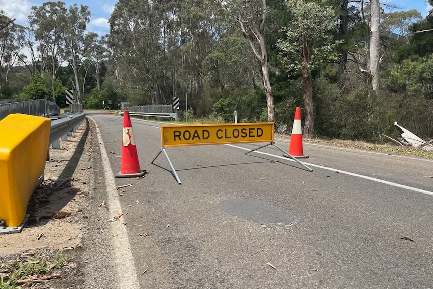 road closed sign on bridge.