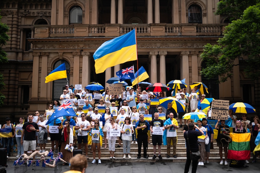 People seem protesting with Ukrainian flags and signs