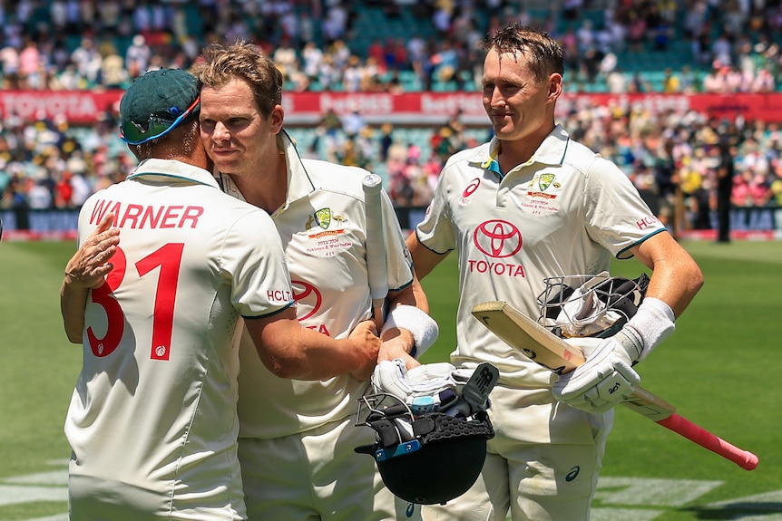 David Warner hugs Steve Smith as Marnus Labuschagne watches on