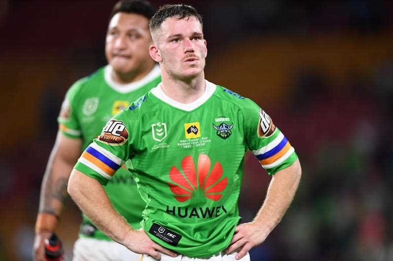 An NRL player stands on afield with his hands on his hips.