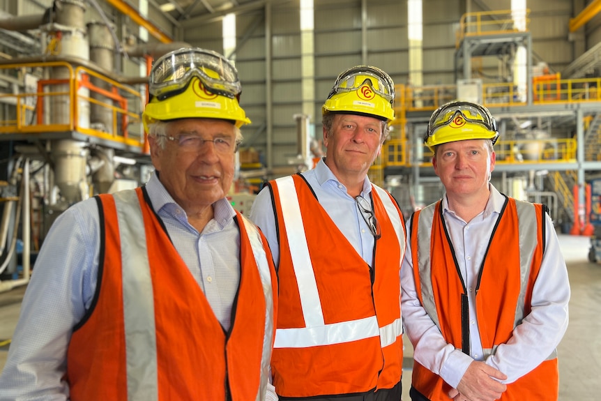 Three men in high-vis vests and hard hats. 