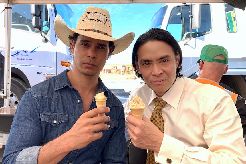 A close of two men holding icecreams