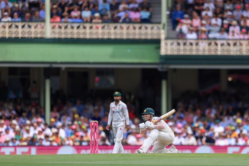 Australia batter David Warner ducks and watches a ball go behind him at the SCG.