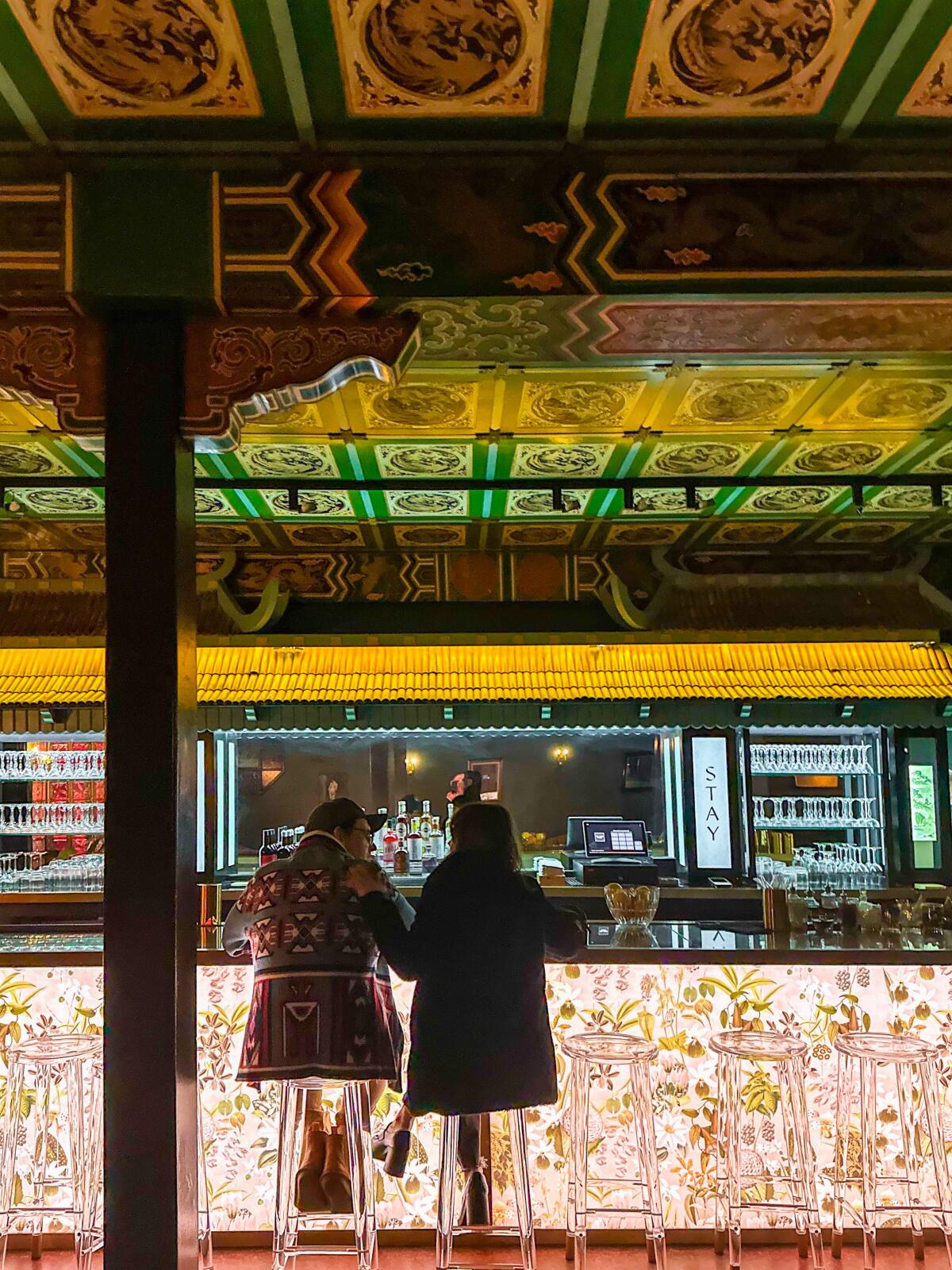 Two people sit at the bar at Stay Zero Proof Cocktail Lounge 