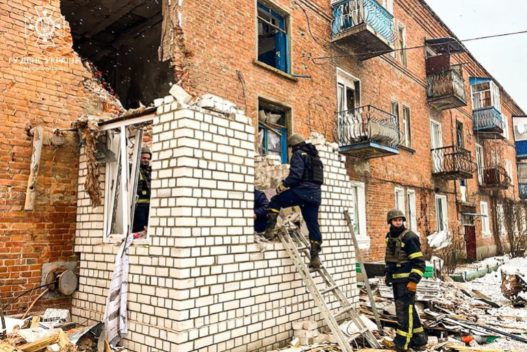 This handout photograph taken and released by Ukrainian Emergency Service on January 18, 2024 shows Ukrainian rescuers working in a residential building damaged after strike in Kupiansk, Kharkiv region, amid Russian invasion in Ukraine