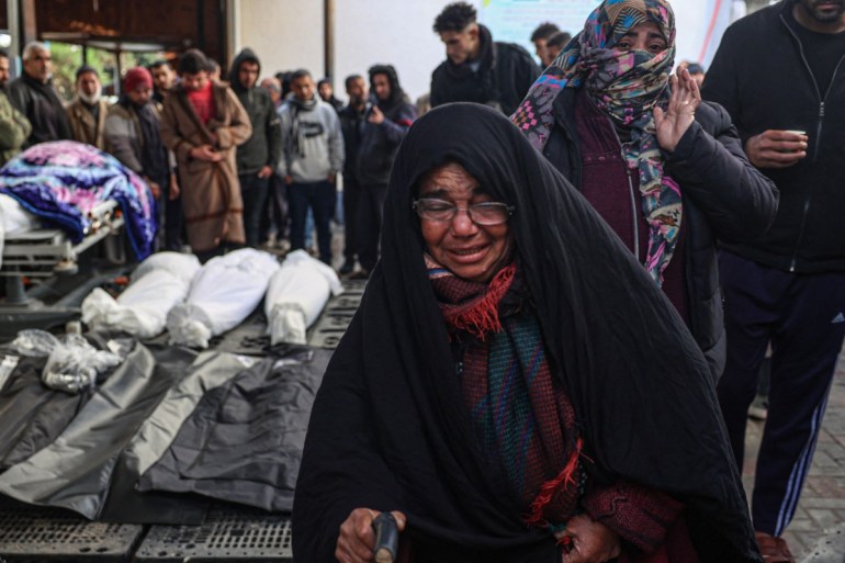 Palestinians wait at a hospital to collect the bodies of their relatives killed in Israeli bombardment in Rafah