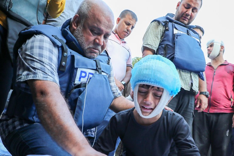 Yehia weeps over the body of his mother with his father Wael beside him