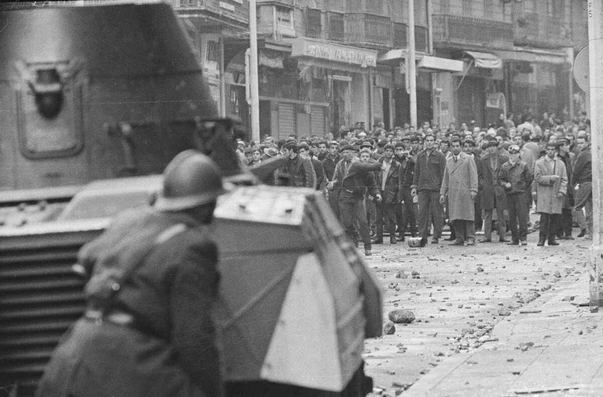 Demonstrators face an armored car in Algiers, 1960, during its revolution against French rule.