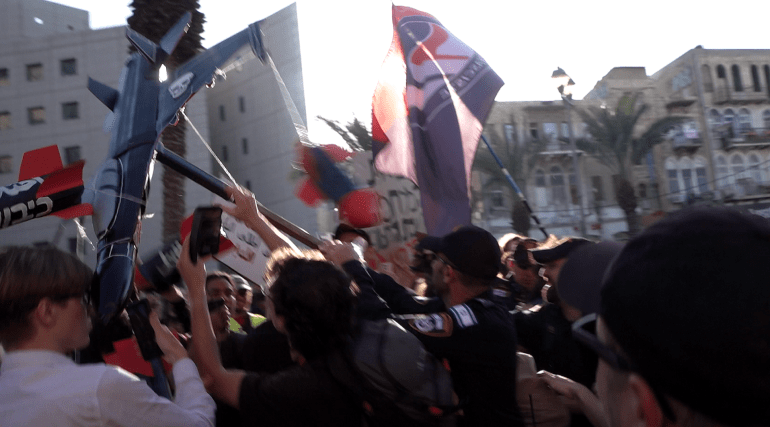 Protesters gather at the first anti-war protest in Israel since October 7 [Alasdair Brenard/Al Jazeera]