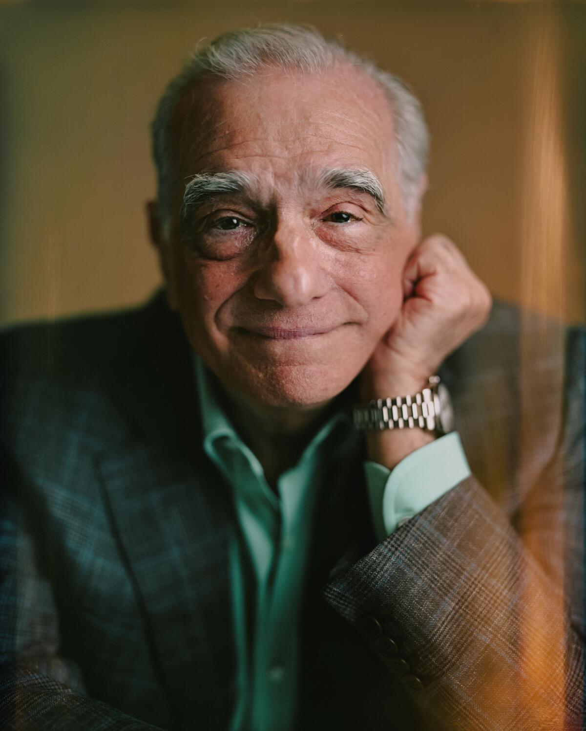 Martin Scorsese leans his chin on his hand for a portrait.