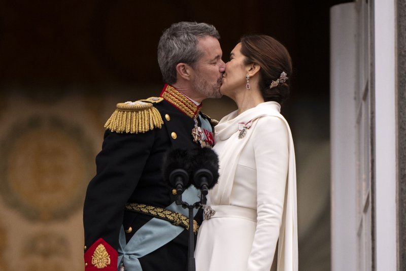 Denmark's King Frederik X (L) and Queen Mary (R) kiss on the balcony after the proclamation of the accession to the throne at Christiansborg Palace Square in Copenhagen, Denmark, on Sunday. Photo by Bo Amstrup/EPA-EFE