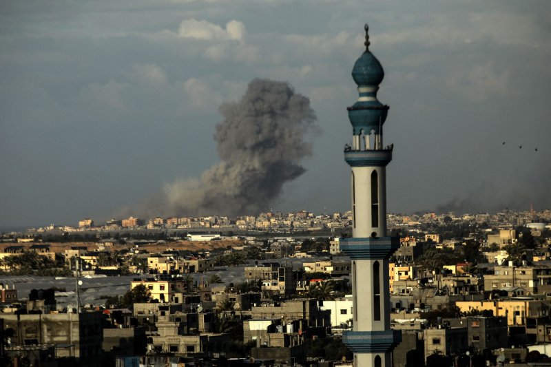 Smoke billows over Khan Younis in the southern Gaza Strip during an Israeli bombardment on Wednesday. Israel Defense Forces are reported to have inflicted "mass casualties" in the region while targeting terrorists activities. Photo by Ismael Mohamad/UPI