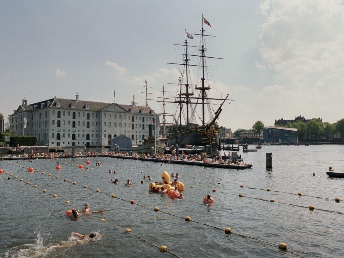 People swim in a huge outdoor pool in Amsterdam.