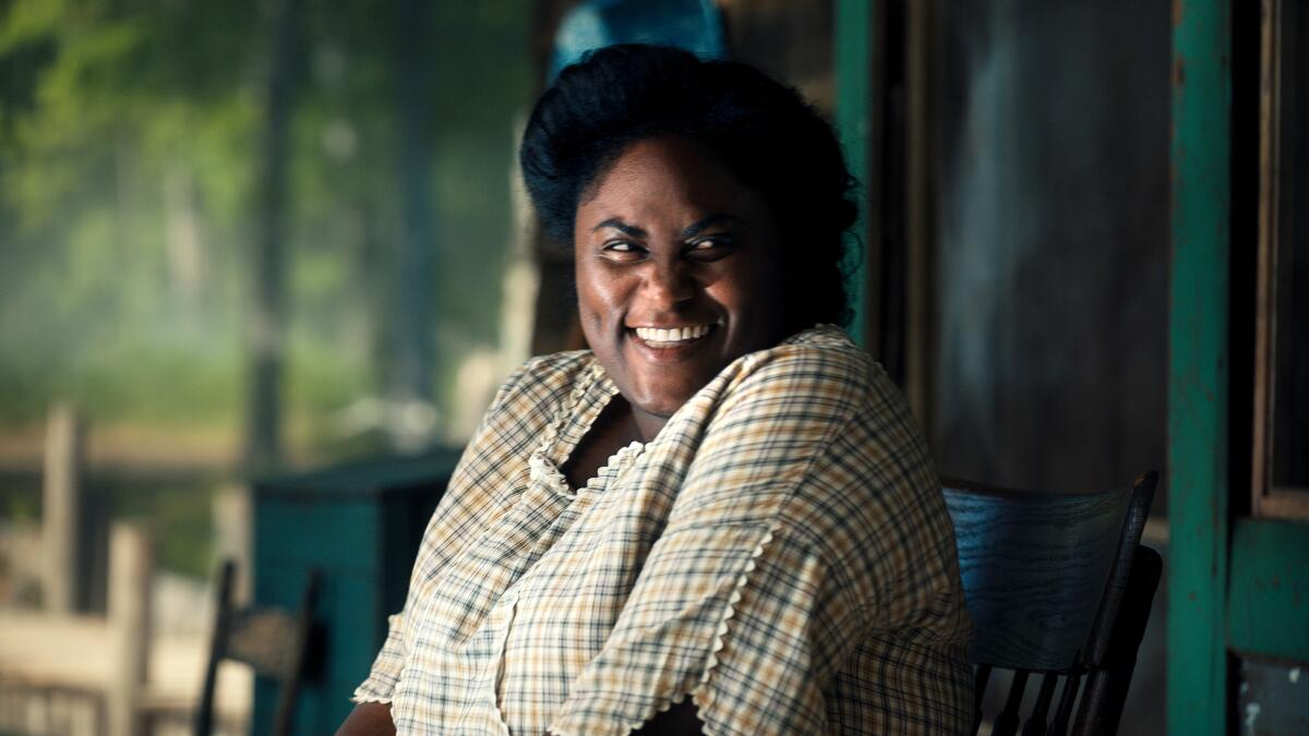 A woman in a 1940s dress smiles enthusiastically