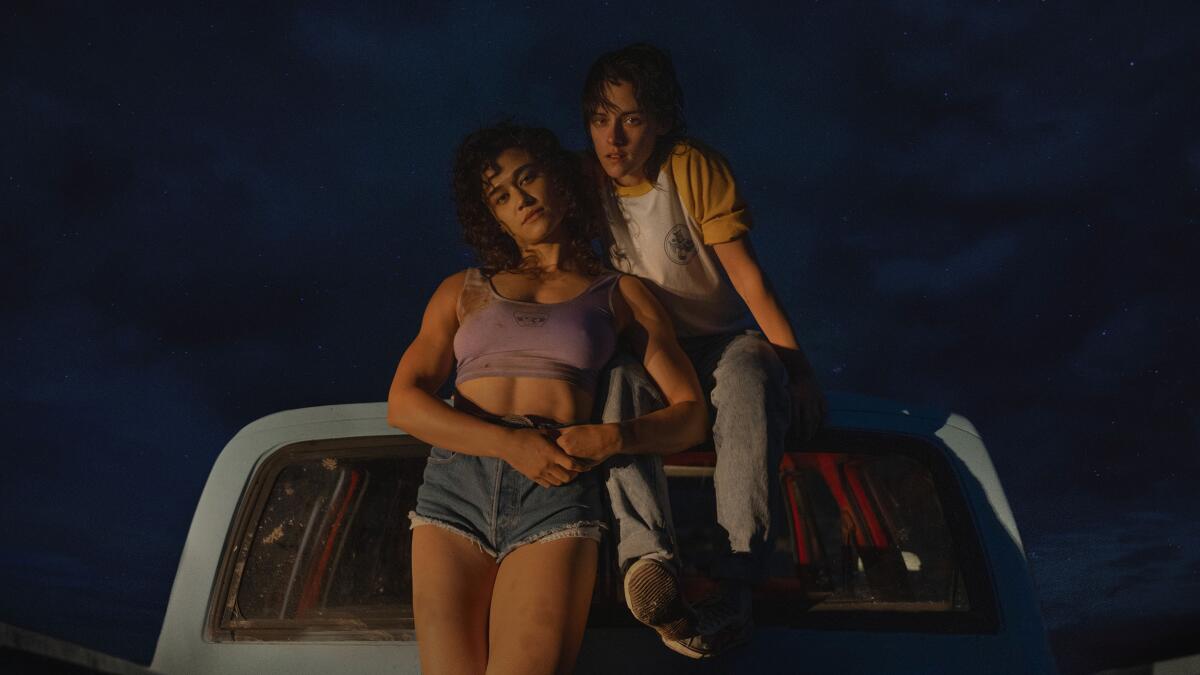 Two women in the cab of a truck at night. 