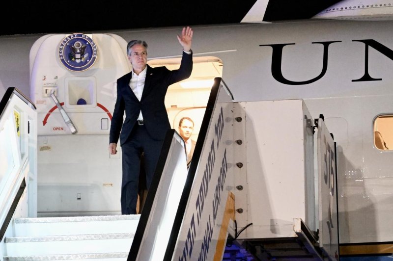 U.S. Secretary of State Antony Blinken waves Monday as he disembarks from his plane after landing at Ben Gurion Airport, outside Tel Aviv, Israel. Blinken's official visit to Israel, his fourth since the October 7 Hamas attack, is part of his trip to the region. U.S. Embassy Jerusalem handout photo by David Azagury for EPA/EFE