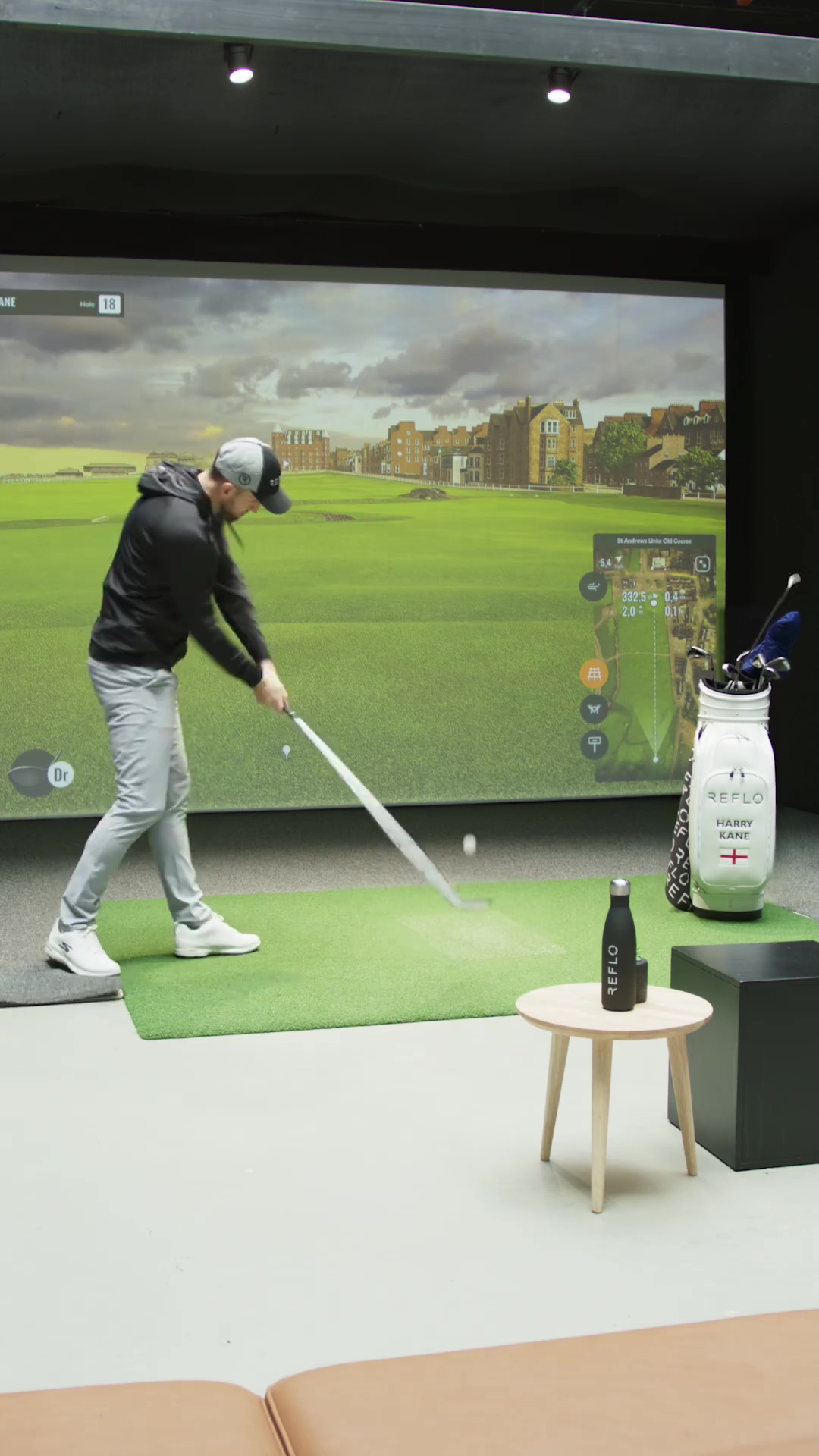 The wedge landed in his golf bag and Kane volleyed the ball at the simulator with his driver