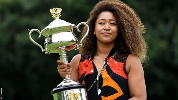 Naomi Osaka poses with the Australian Open trophy