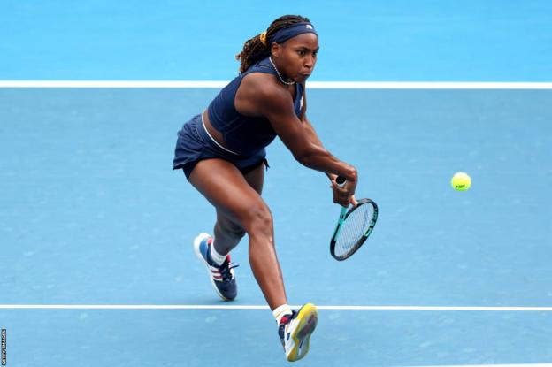 Coco Gauff swings to hit the ball