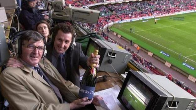 Bill McLarren and Jonathan Davies holding bottle of champagne