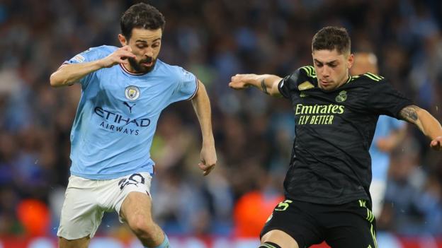 Manchester City's Bernardo Silva and Federico Valverde of Real Madrid competing for the ball