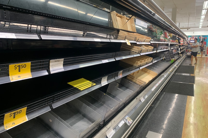 Bare shelves in the fresh produce section of a supermarket.