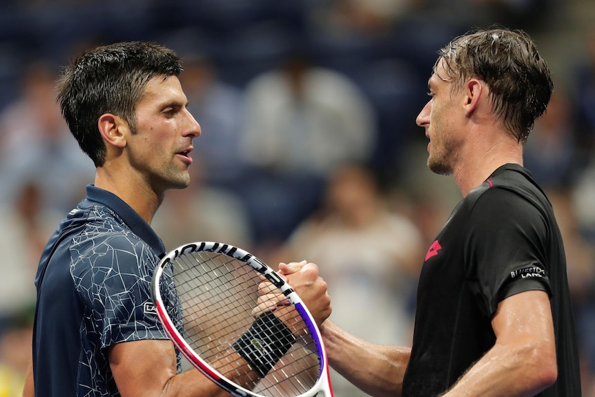 John Millman shakes hands with Novak Djokovic