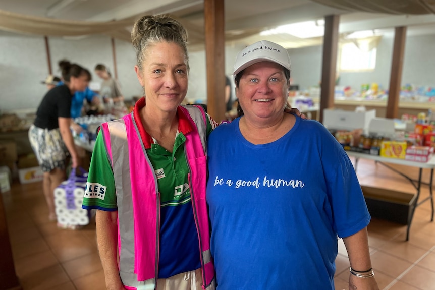 Two women standing side by side at a food bank