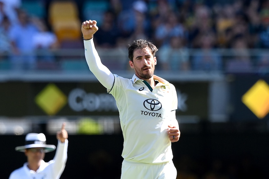 Mitch Starc holds up a clenched fist