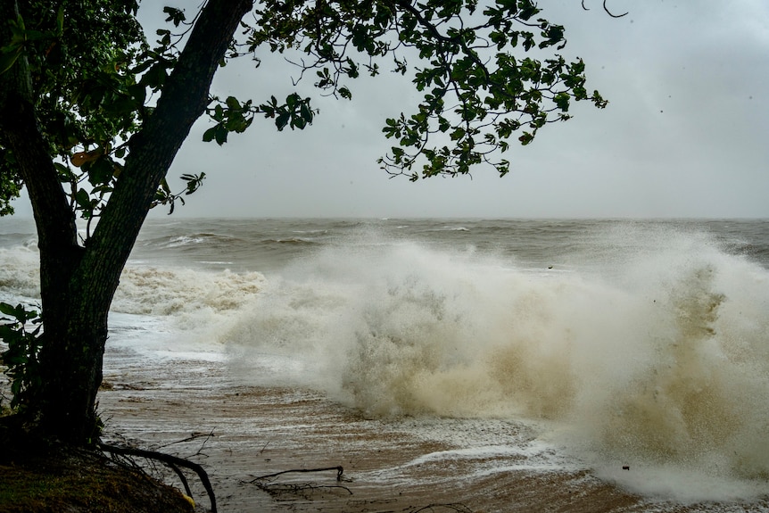 crashing waves with grey storm clouds overhead