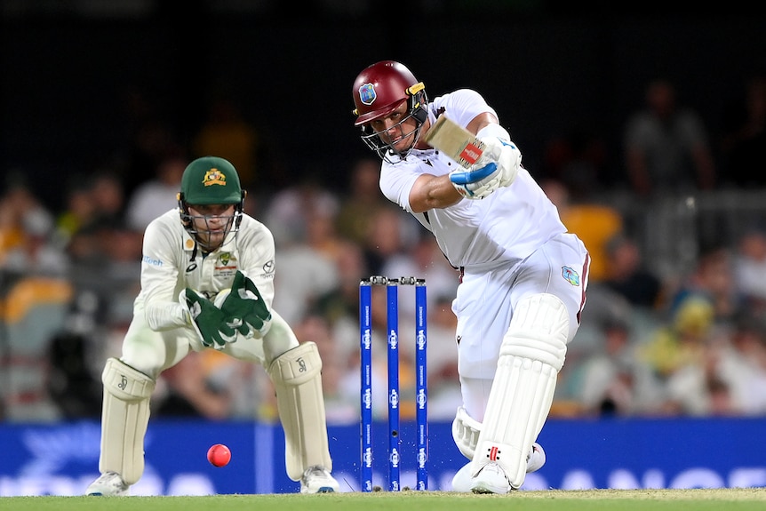 Josh Da Silva drives as Alex Carey watches behind the stumps