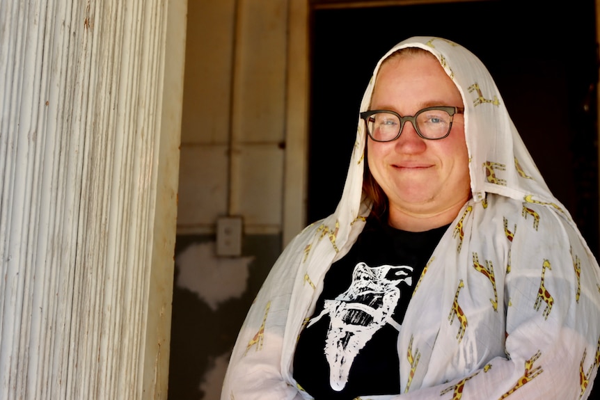 woman with glasses and white wet cloth on her head