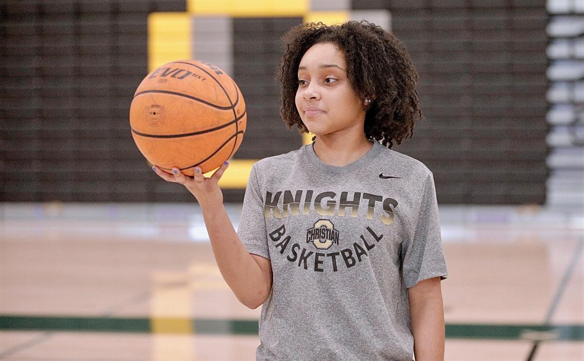 Ontario Christian freshman basketball star Kaleena Smith poses for a photo holding a basketball in her right hand.