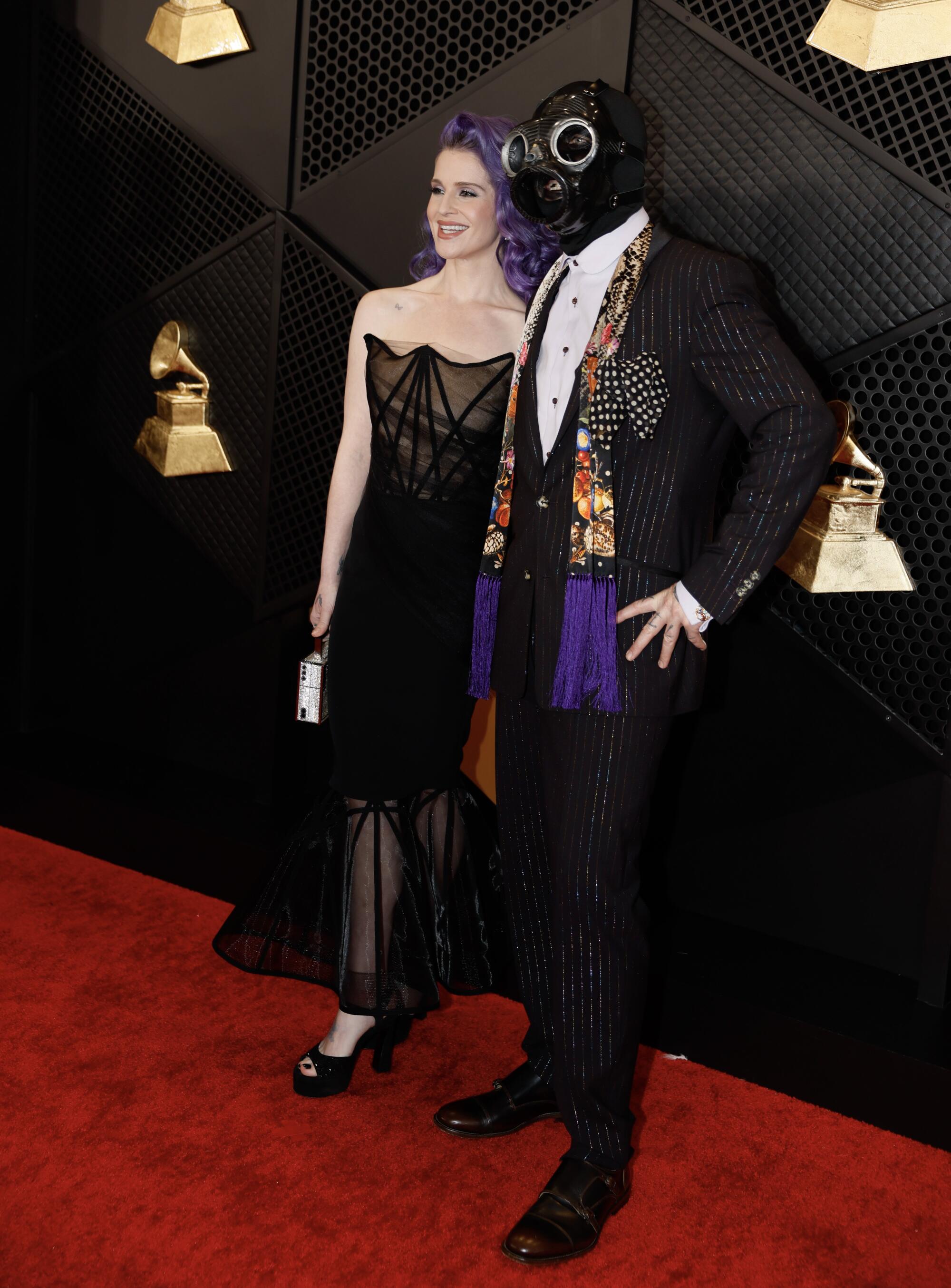 Kelly Osbourne and Sid Wilson of Slipknot arrive on the Grammys red carpet. 