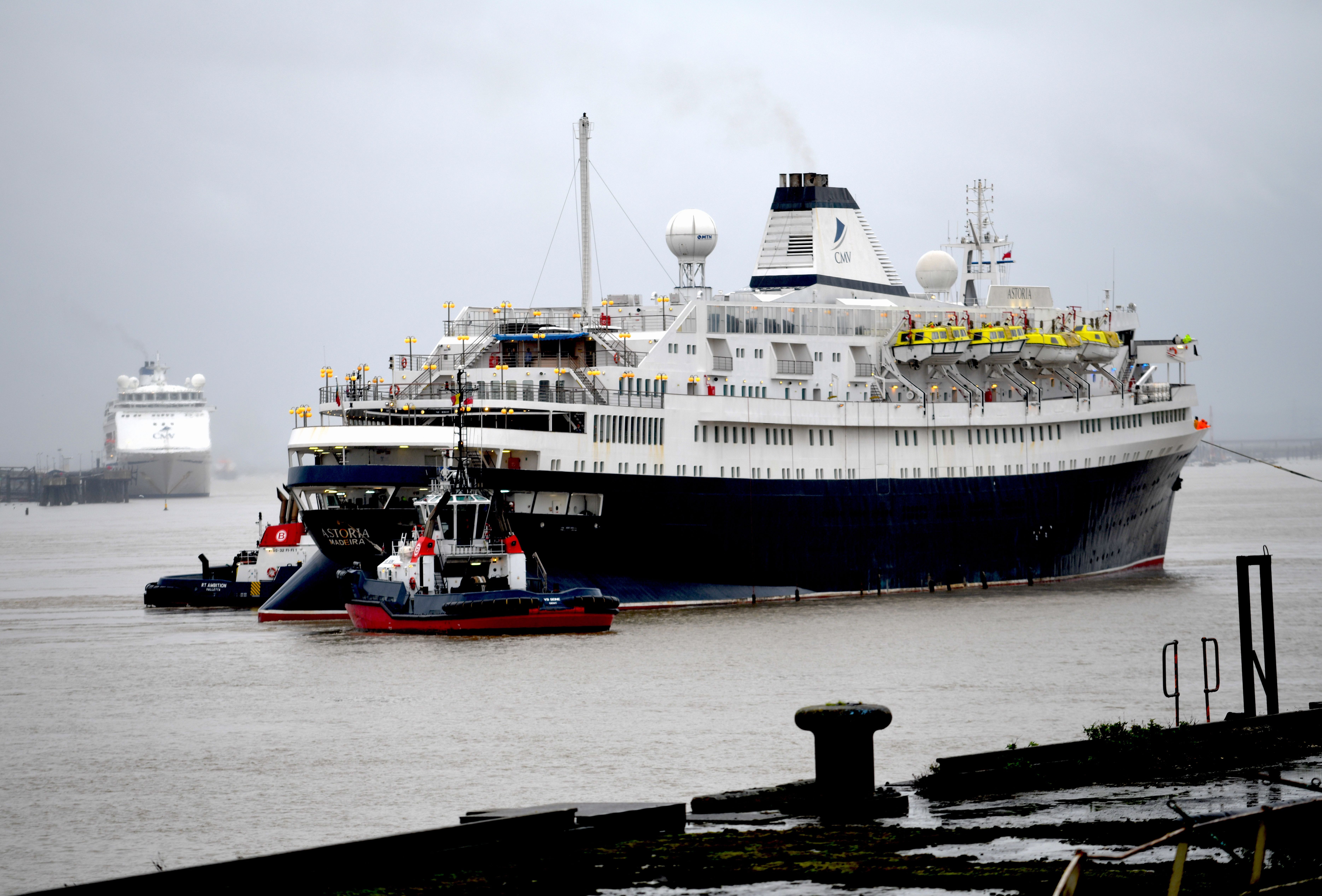 Astoria leaving Tilbury Docks and passing her former fleet mates Magellan and Columbus