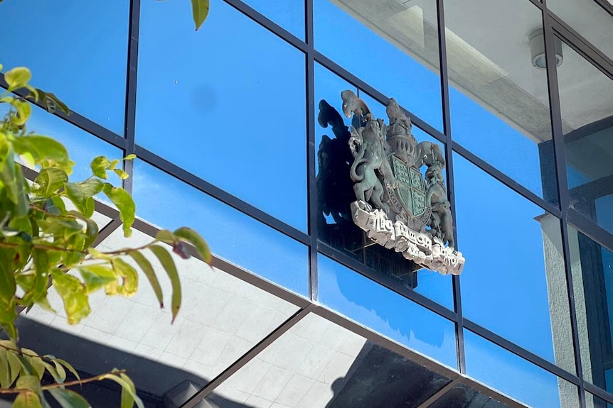 A shield sits on glass windows