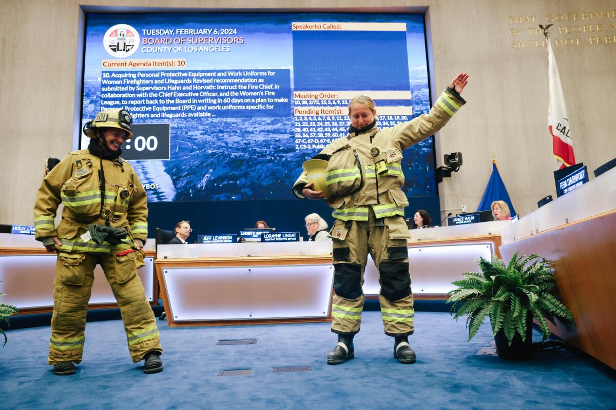 Female firefighters demonstrate specific concerns they have wearing personal protective equipment designed for men.