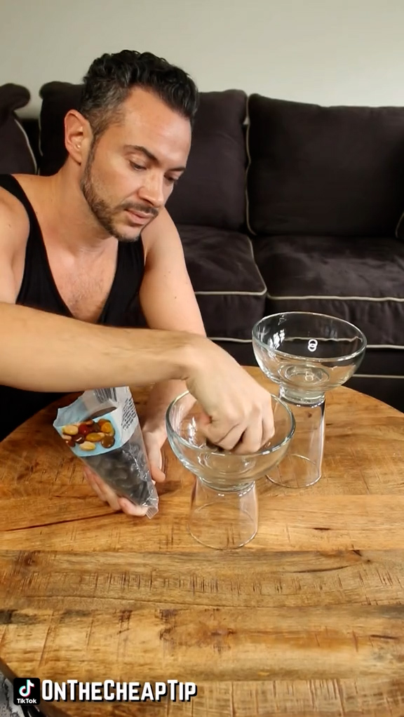 He glued together a glass bowl and glasses to create a simple candle holder