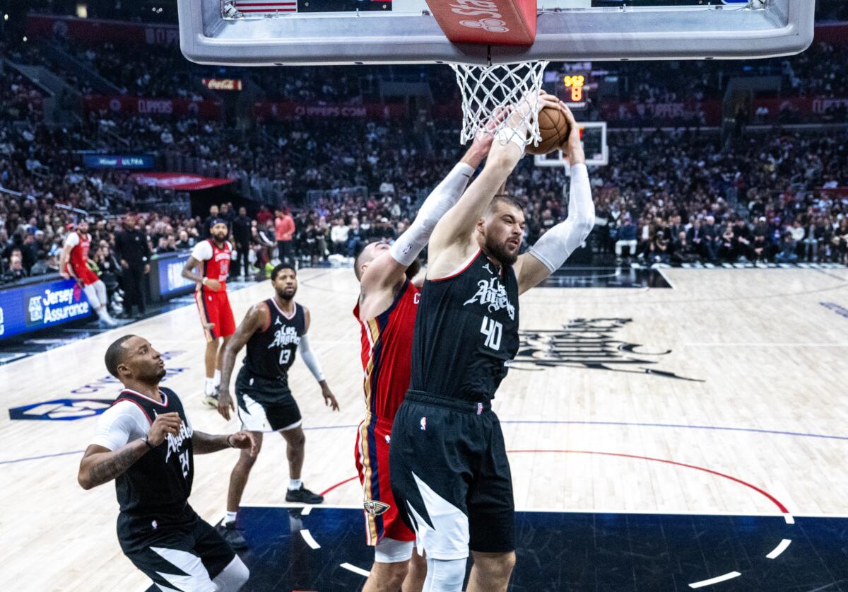 Clippers center Ivica Zubac blockd out Jonas Valanciunas for a defensive rebound in the first half.