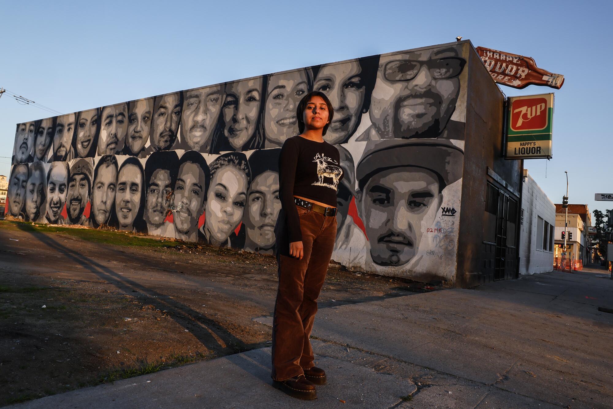 Domaris Cid stands before a mural in Chinatown. 