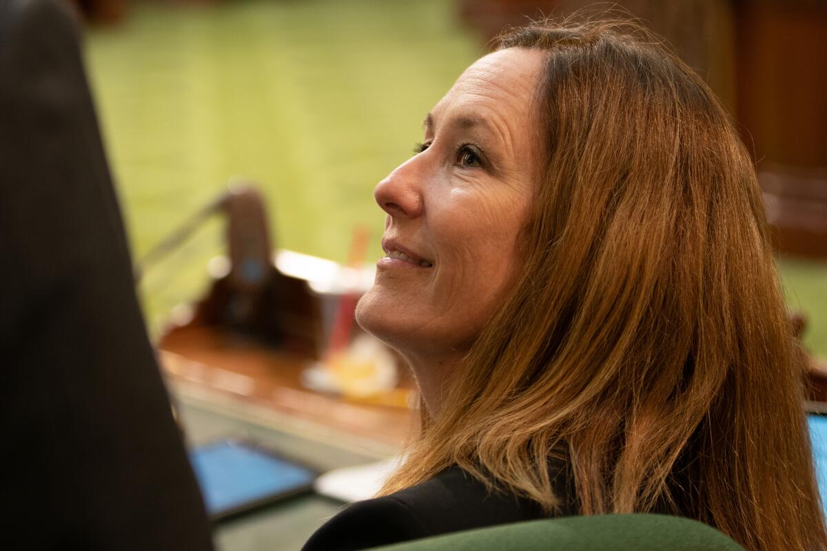 A side view of a woman's head tilting up.