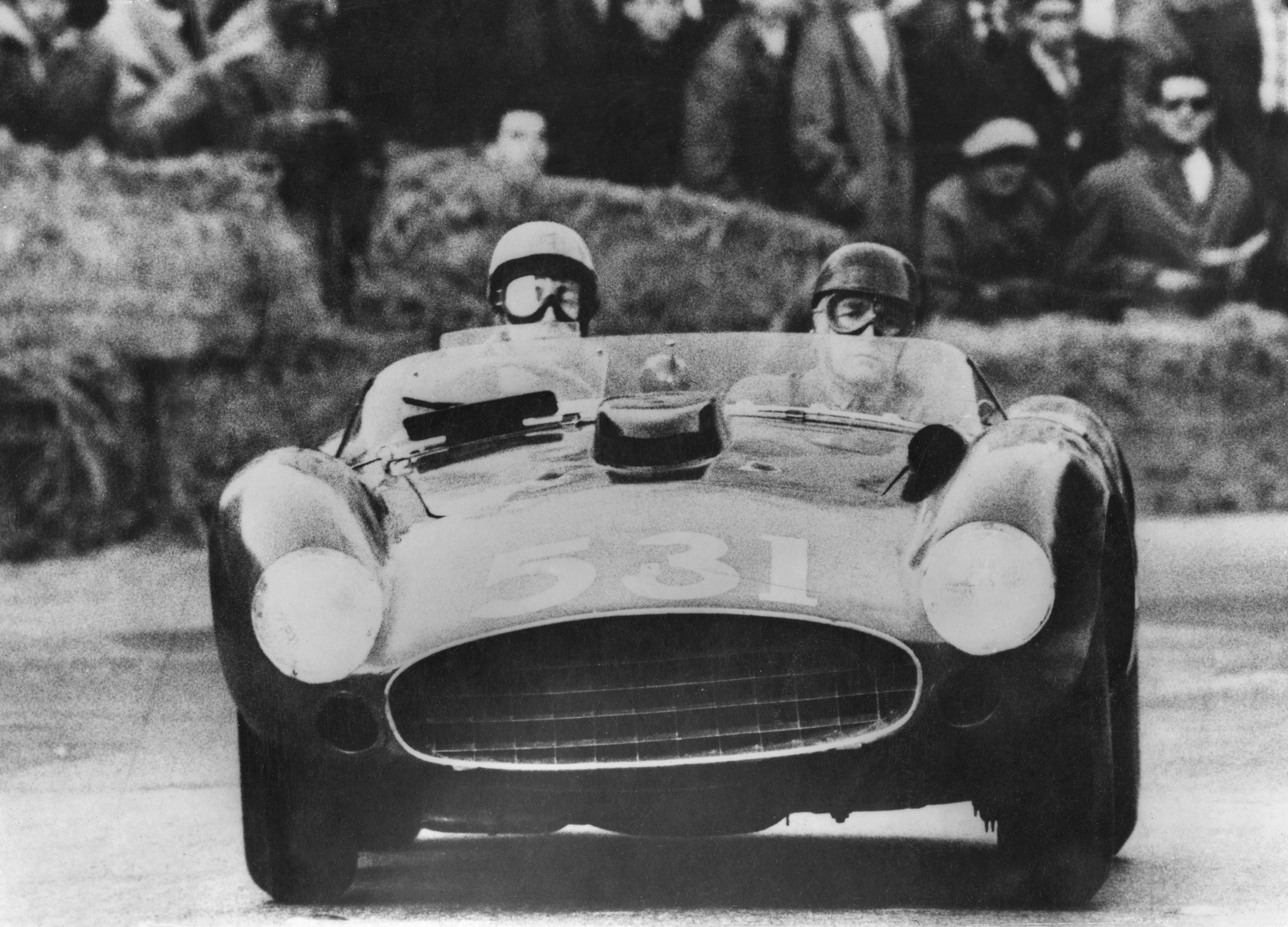 Alfonso de Portago and his co-driver Edmund Nelson in their Ferrari during the Italian Mille Miglia road race in 1957