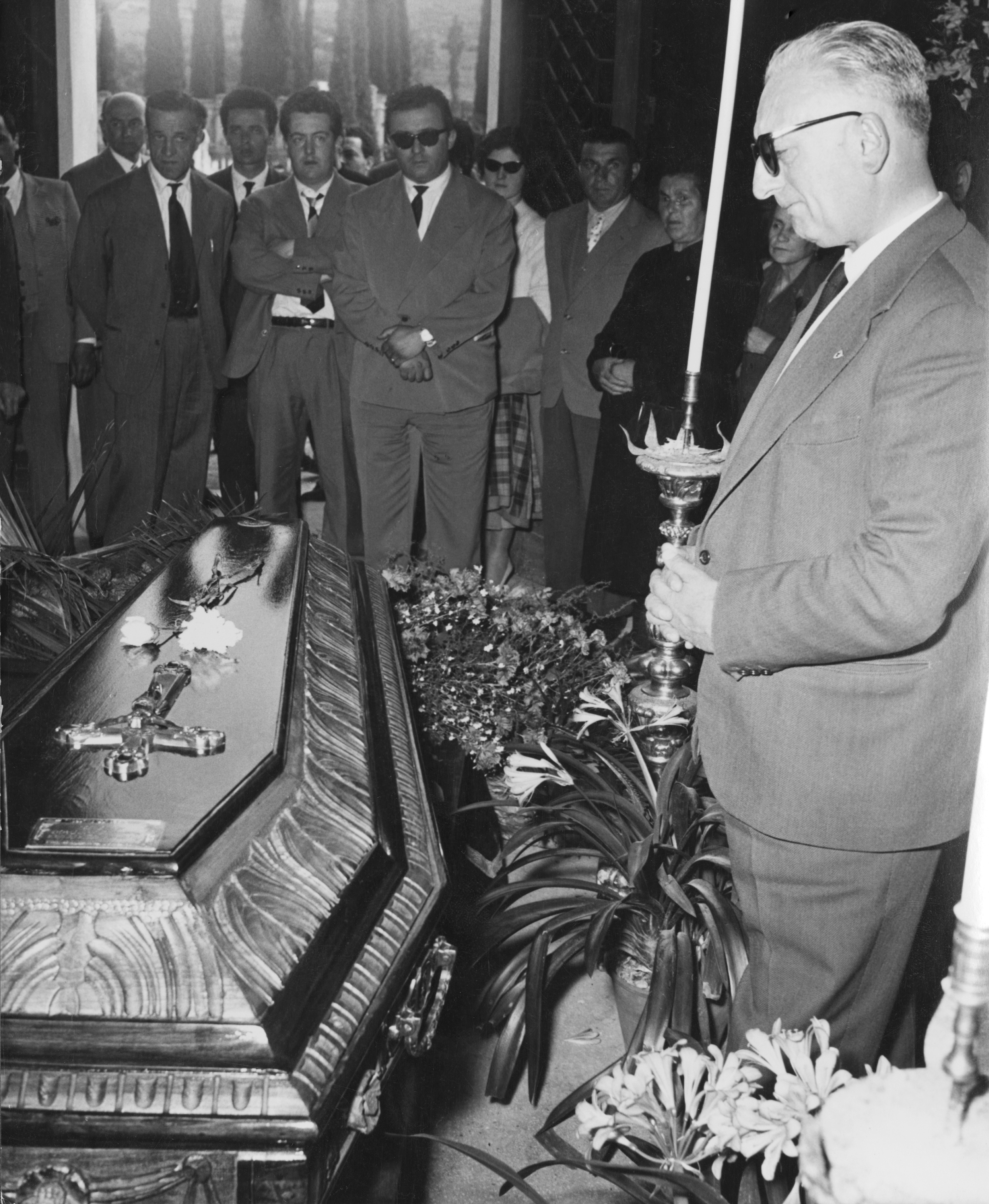 Enzo Ferrari attends the funeral of Spanish racing driver Alfonso de Portago