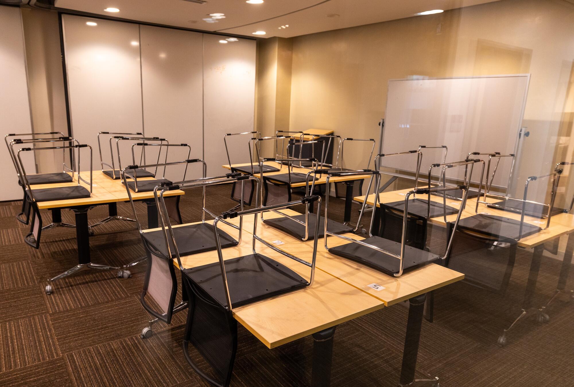 Empty classrooms with chairs up on desks at the Academy of Media Arts school.